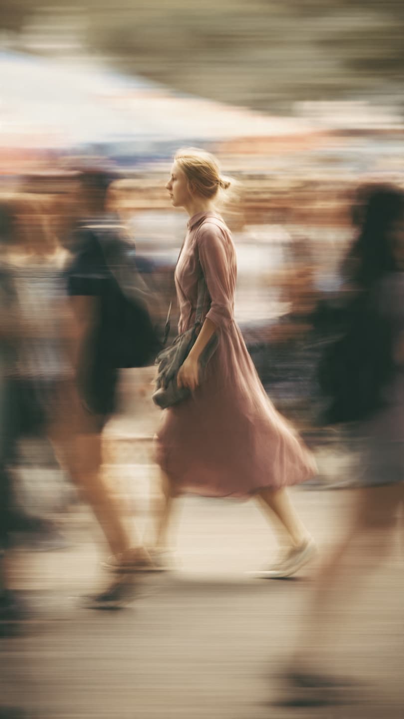 A panning photo of a female model mid walk